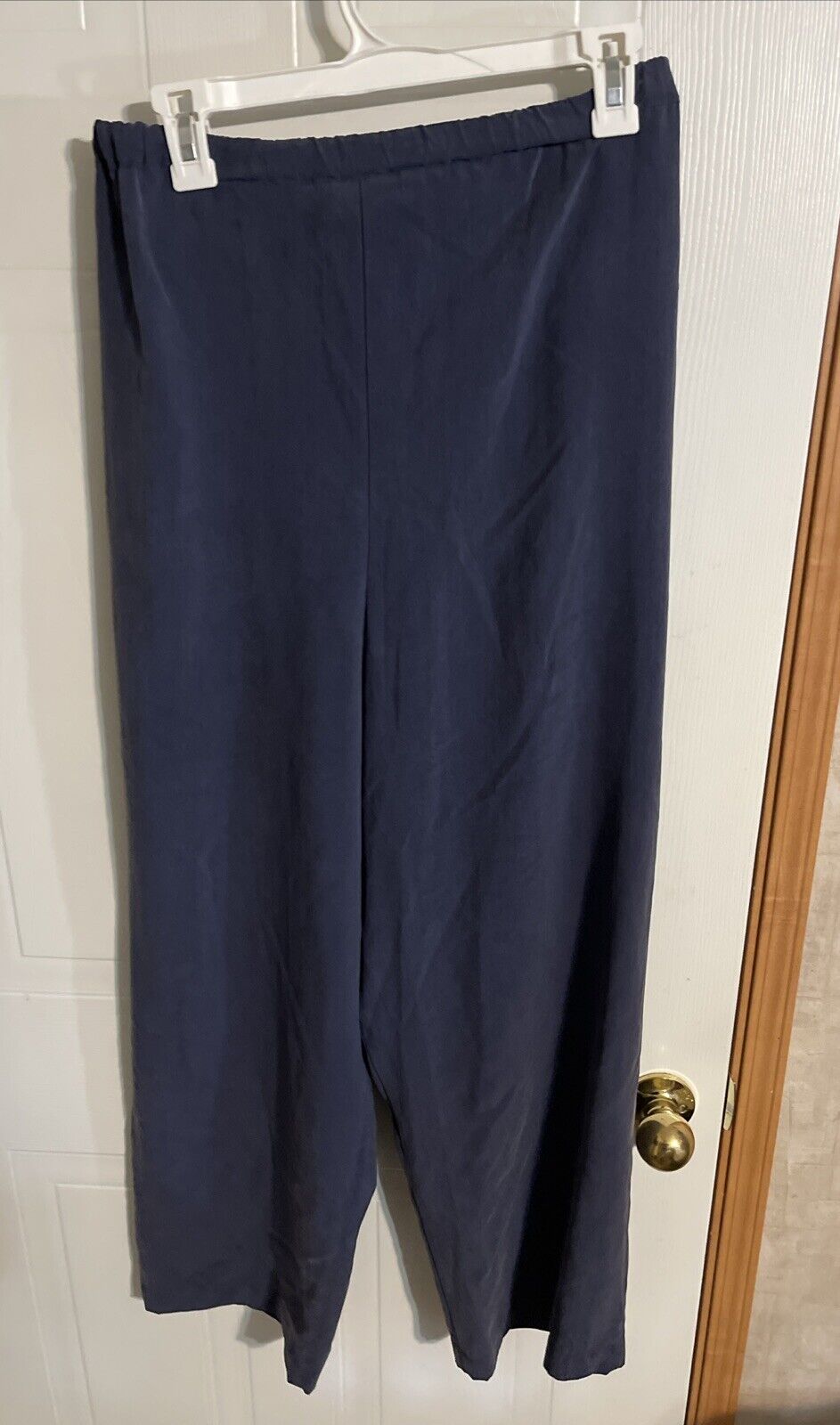 Navy blue 1010 Design silk loungewear pants with elastic waistband hanging on white hanger