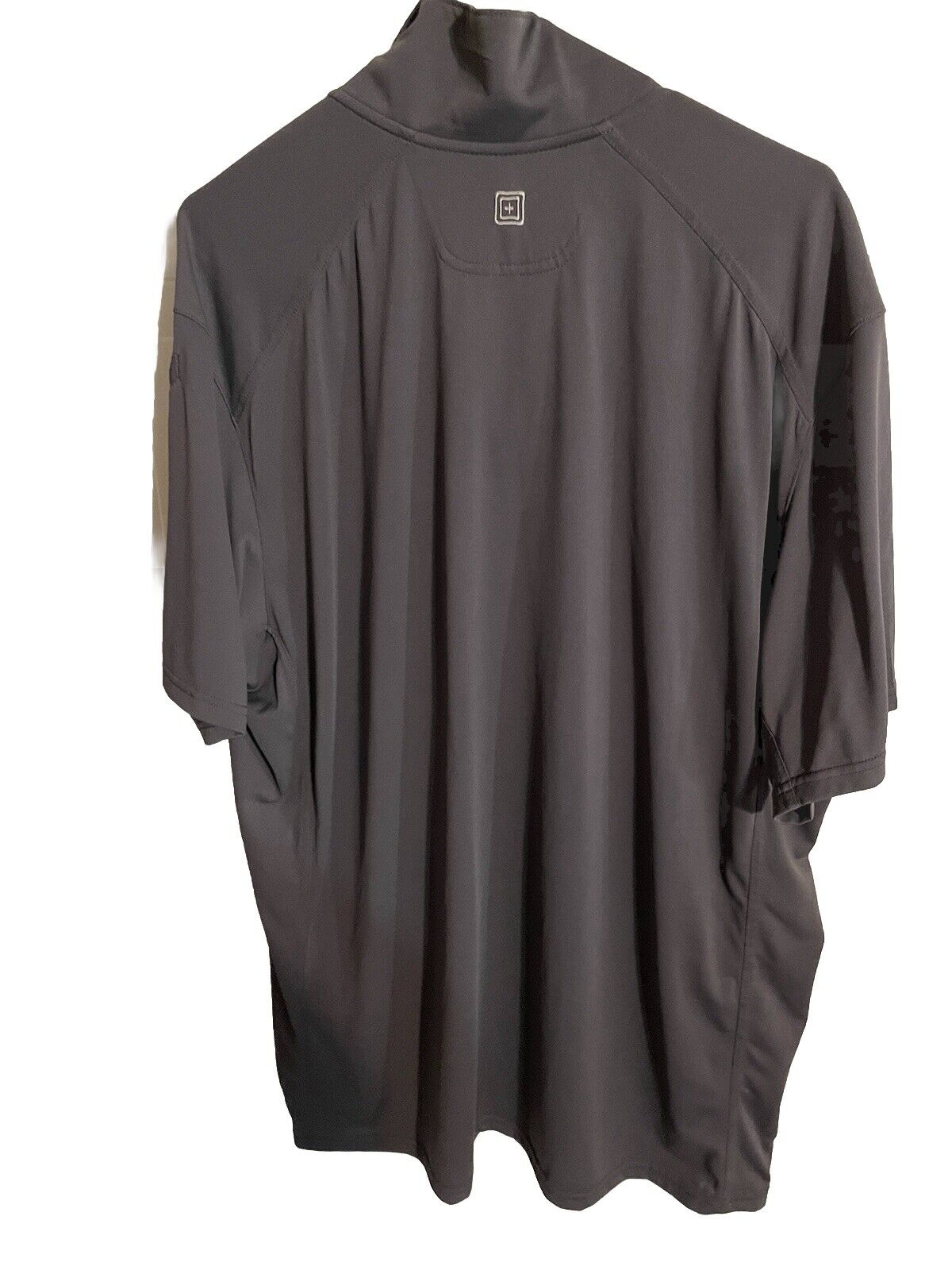 1118 Emporium black performance tactical polo for men displayed from the back with short sleeves