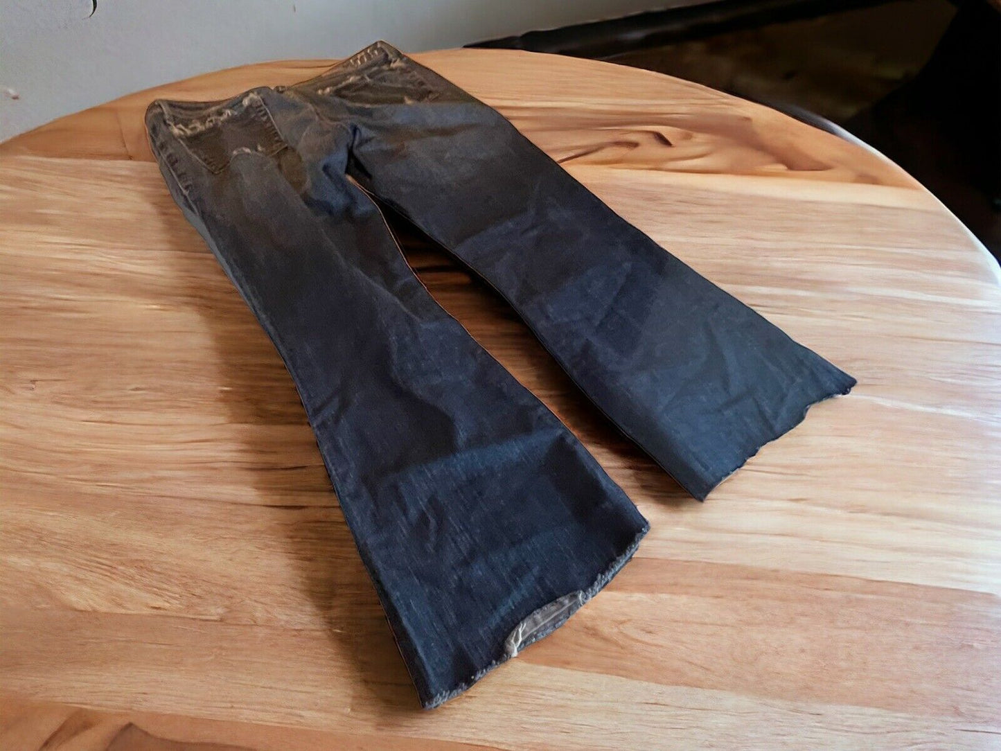 575 Brand women's jeans in black with bootcut style laid flat on wooden table by 1118 Emporium