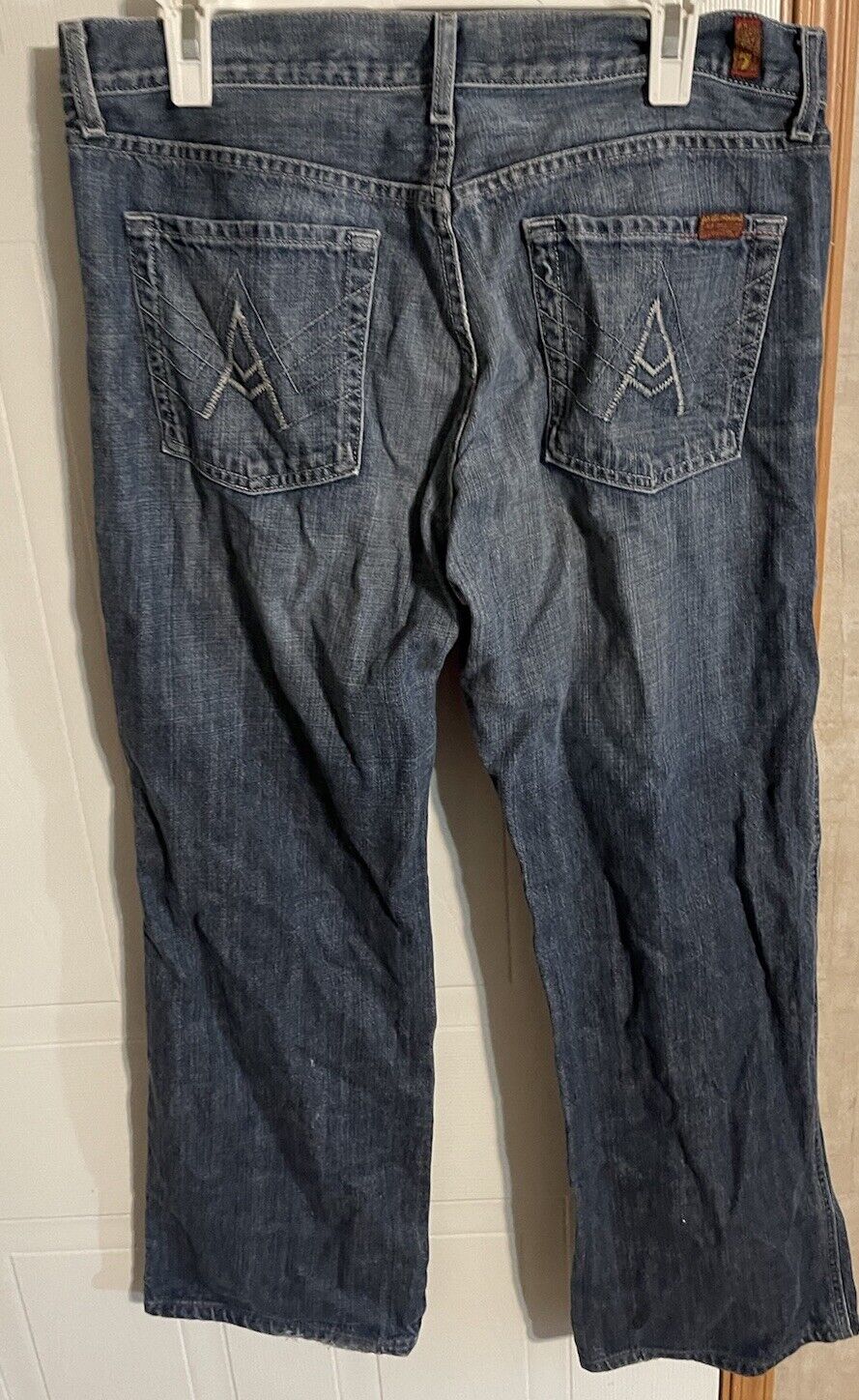 Back view of 7 For All Mankind A Pocket Jeans in faded blue denim with stitched back pockets