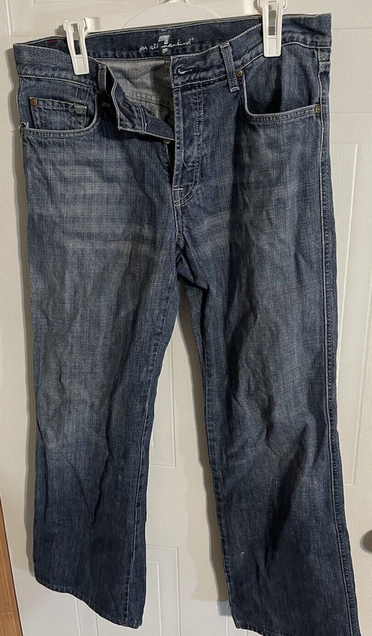 7 For All Mankind A Pocket Jeans in dark blue denim hanging with button and zipper open