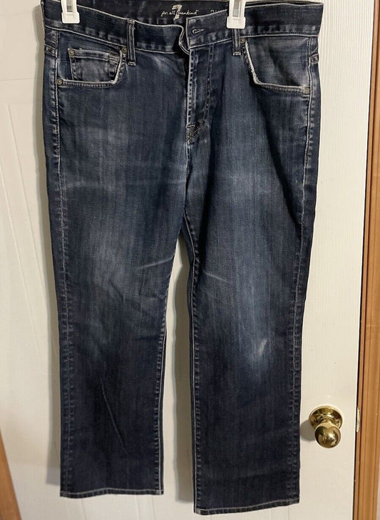 Dark wash 7 For All Mankind Austyn Jeans with front pockets and belt loops hanging on white clips