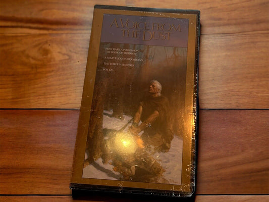 A Voice From The Dust VHS tape featuring a man sitting by a campfire in a snowy forest