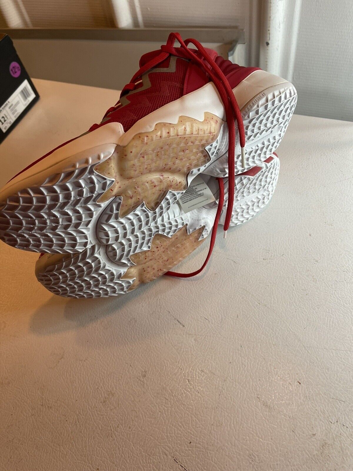 Pair of red adidas D.O.N. Issue 2 size 13 basketball shoes showcasing textured white outsoles and red laces