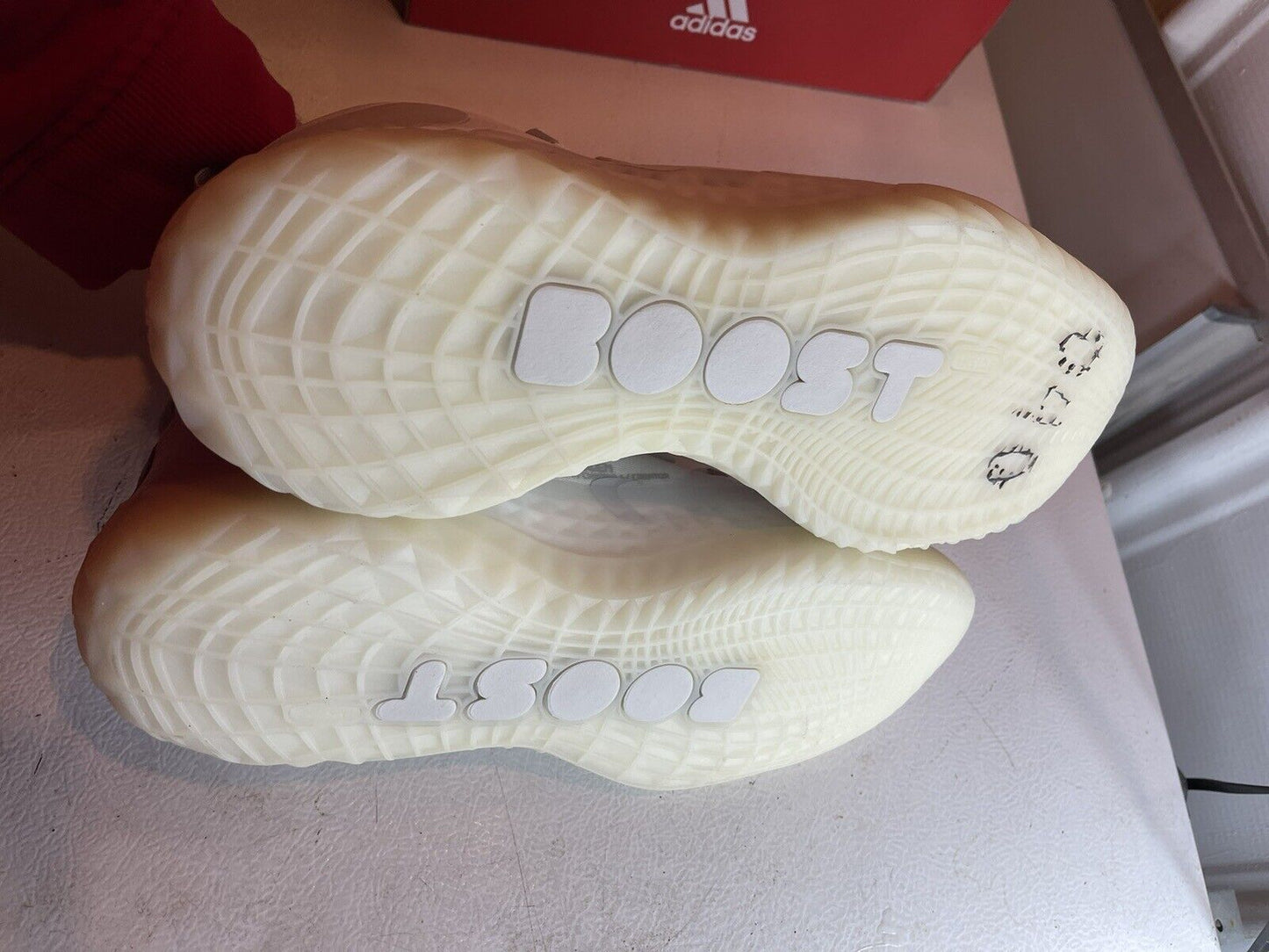 Soles of Adidas Harden Vol 5 Futurenatural basketball shoes showing Boost cushioning technology