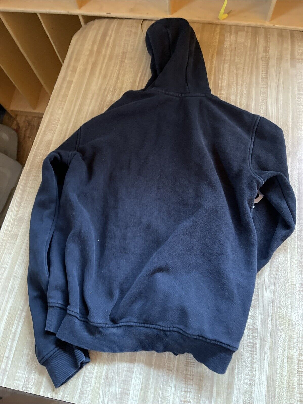 Black Adidas hoodie medium laid flat showing back side with hood and long sleeves
