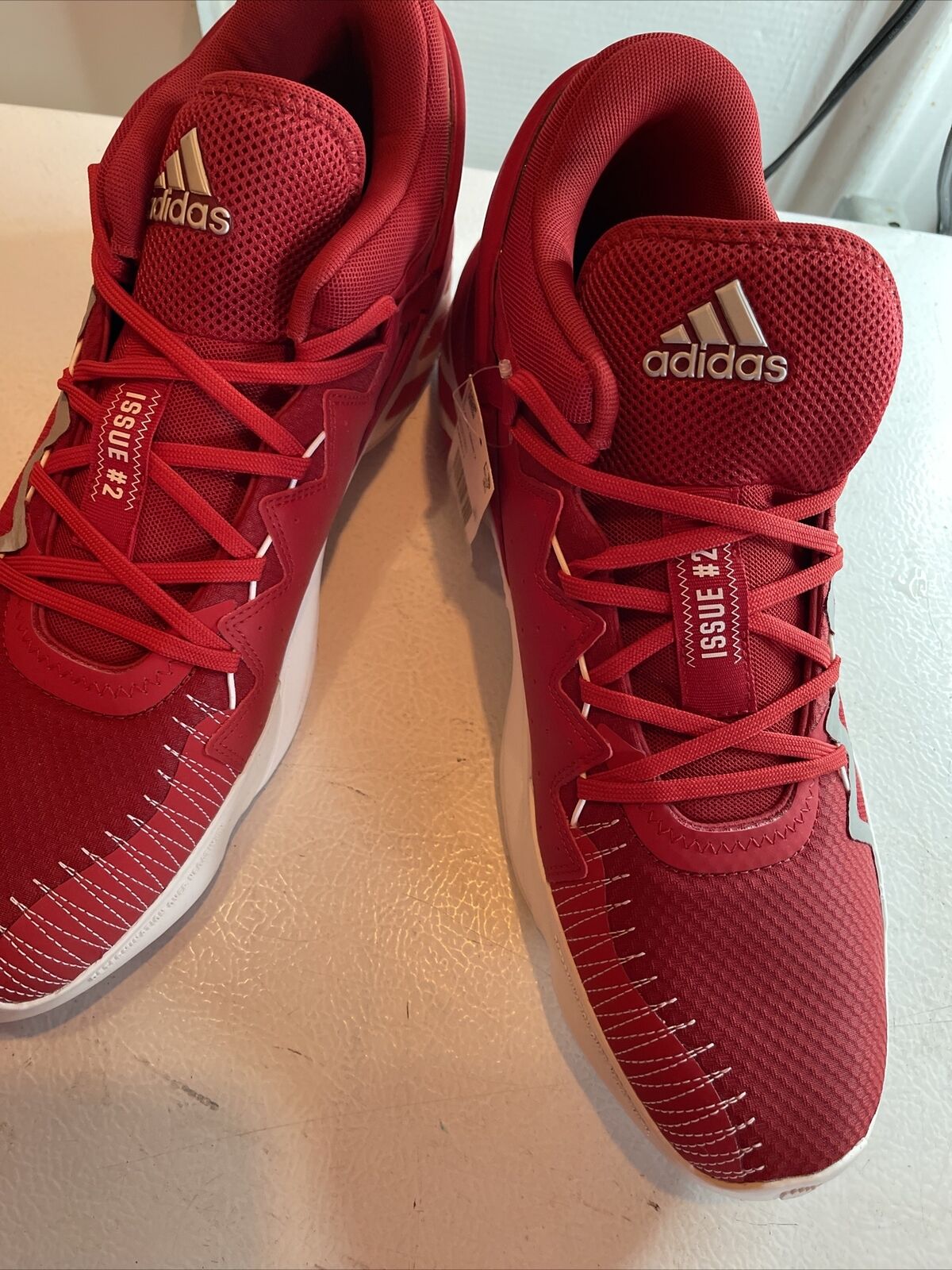 Men's red adidas basketball shoes with white stitching and lace-up design by 1118 Emporium