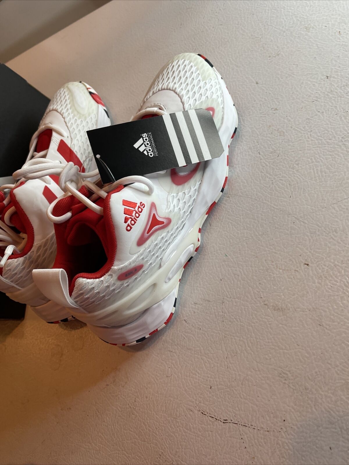 White and red Adidas SM Exhibit A Team USA sneakers with mesh upper and athletic design