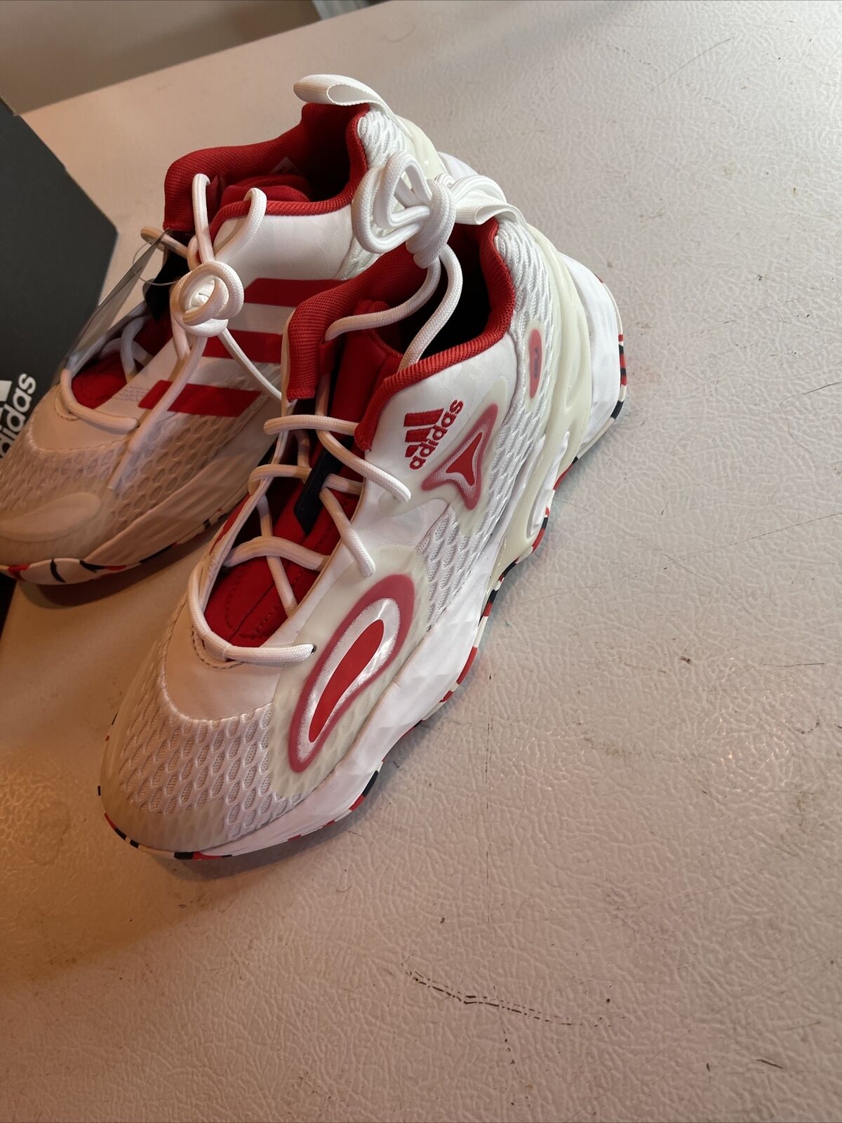 White and red Adidas SM Exhibit A Team USA athletic shoes with mesh design and unique lacing system