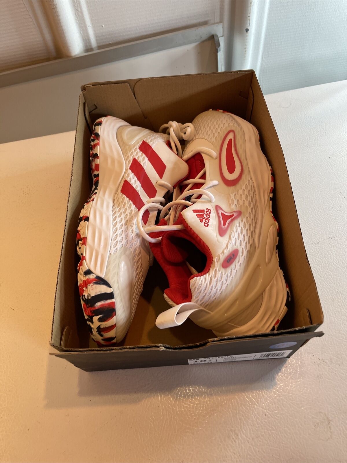 Adidas SM Exhibit A Team USA sneakers in white and red with patterned soles inside a cardboard box
