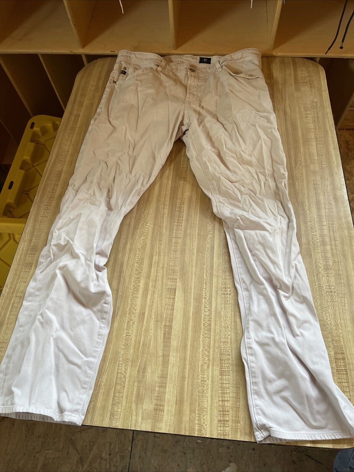 Light beige Adriano Goldschmied pants 36x32 laid flat on a wooden surface from 1118 Emporium