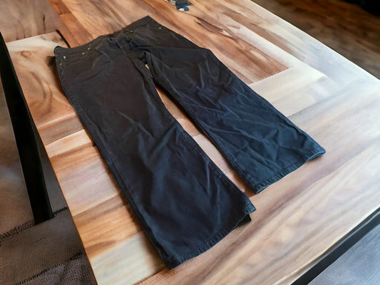 Black Adriano Goldschmied Protege jeans laid flat on wooden table showing full length and relaxed fit