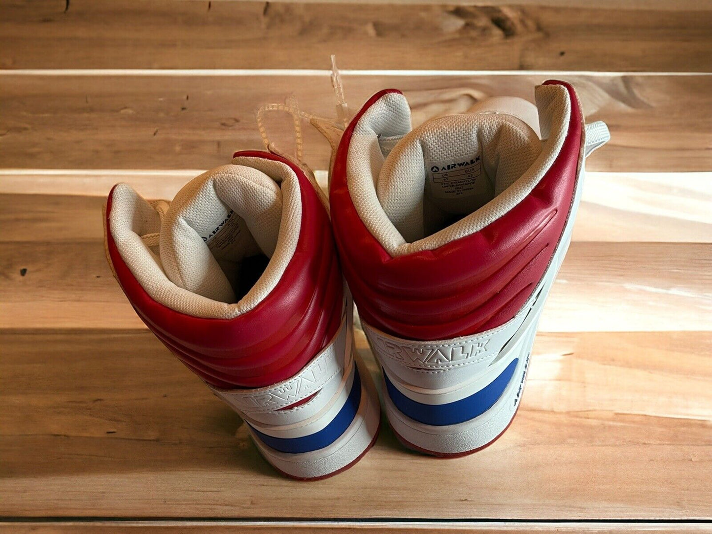 Pair of Airwalk men’s sneakers size 10 in white with red and blue accents viewed from the back