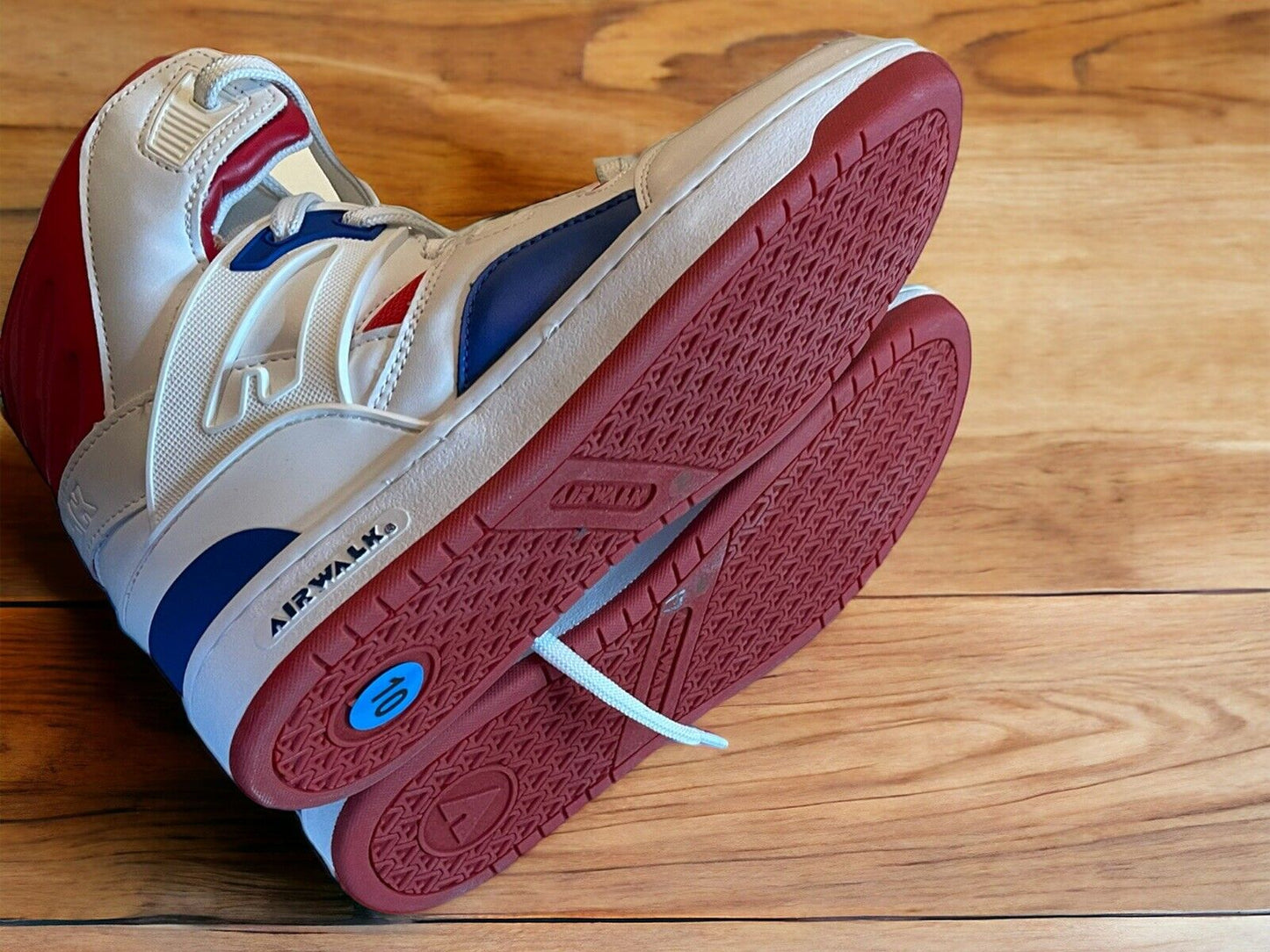 Airwalk men’s sneakers size 10 in white with red and blue accents on wooden floor