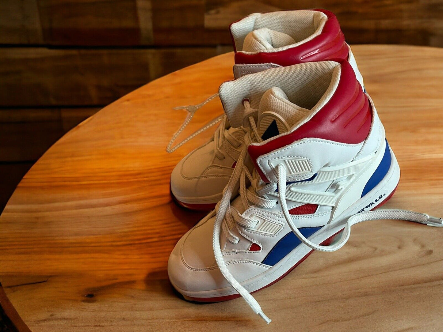 Airwalk men’s sneakers size 9.5 in white with red and blue accents on a wooden surface