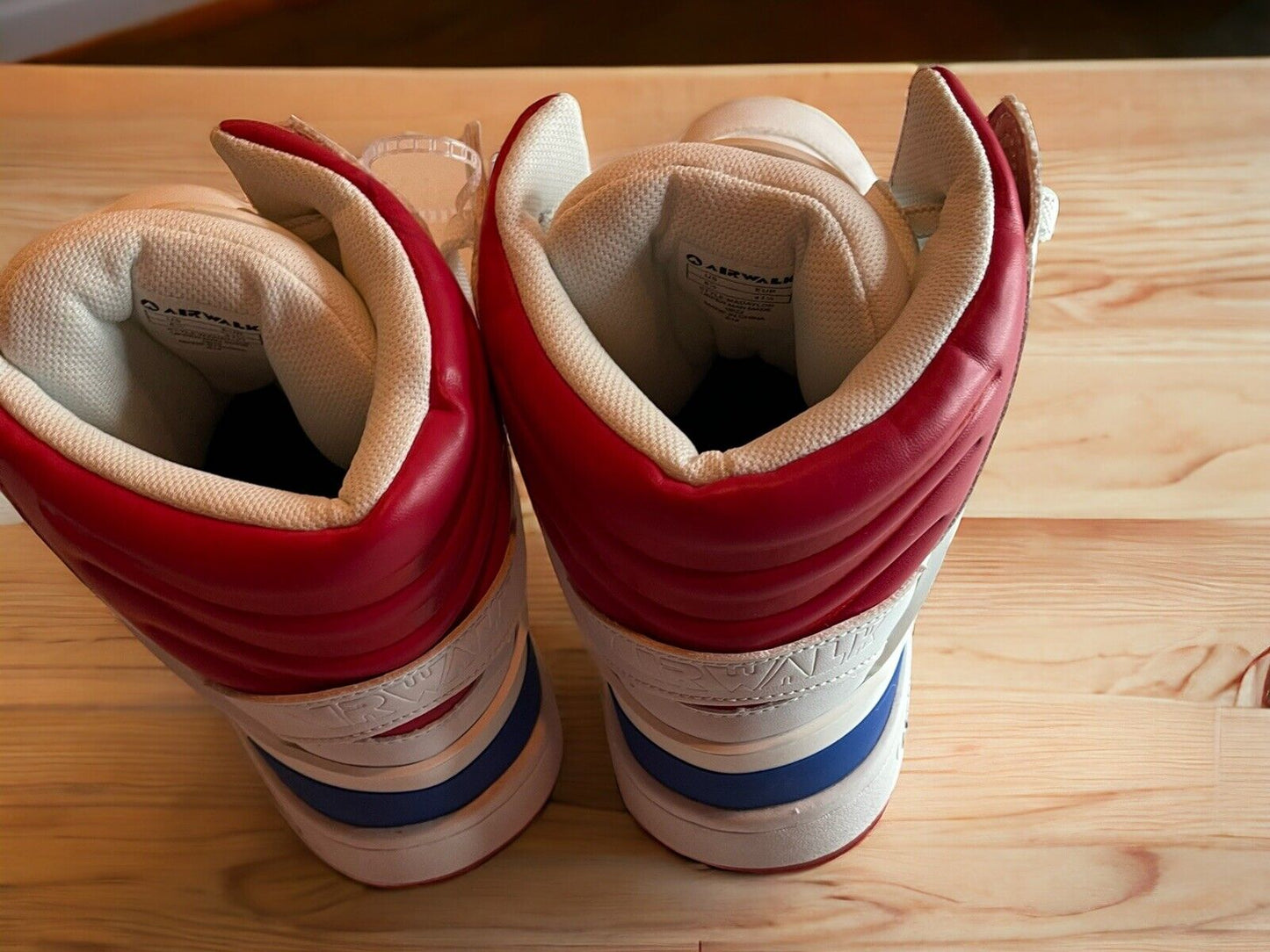 Airwalk sneakers size 8.5 with red, white, and blue high-top design on wooden surface