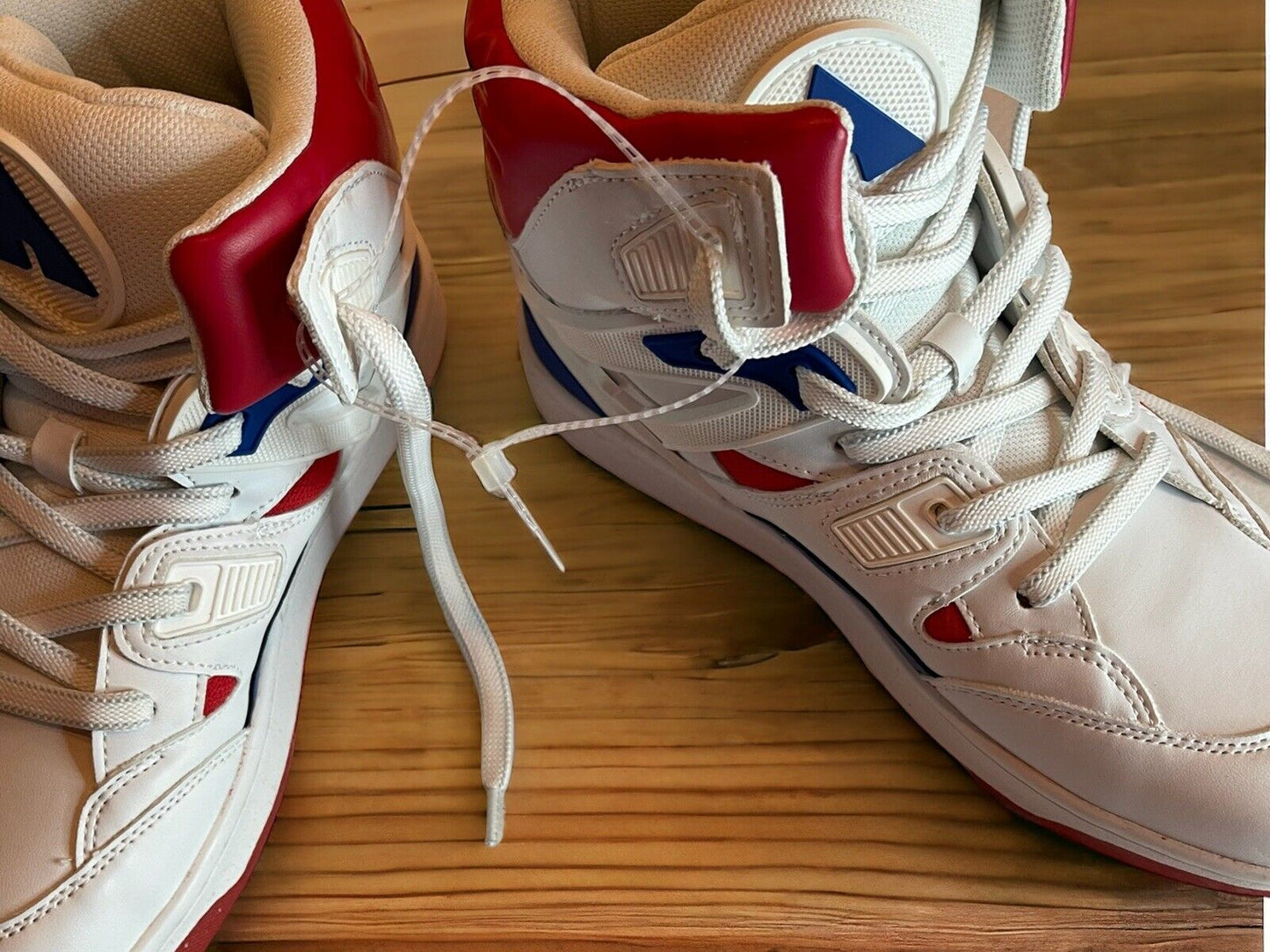 White and red Airwalk sneakers size 8.5 with blue accents on wooden floor