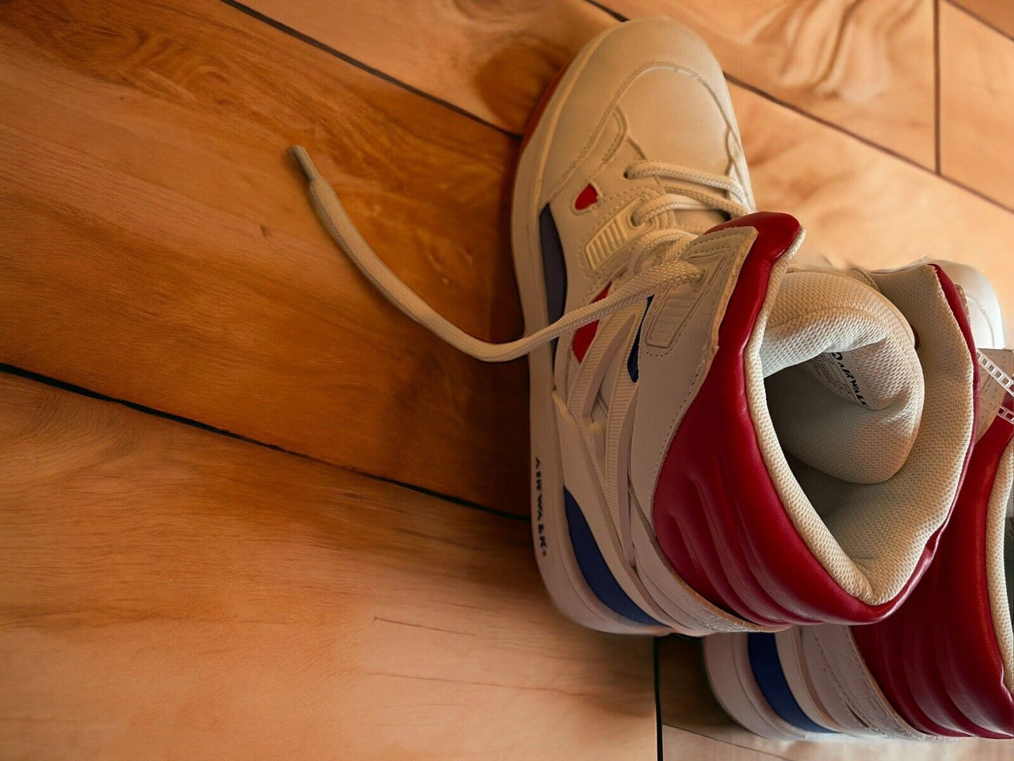 White and red Airwalk sneakers size 8.5 on a wooden floor showcasing side and top details