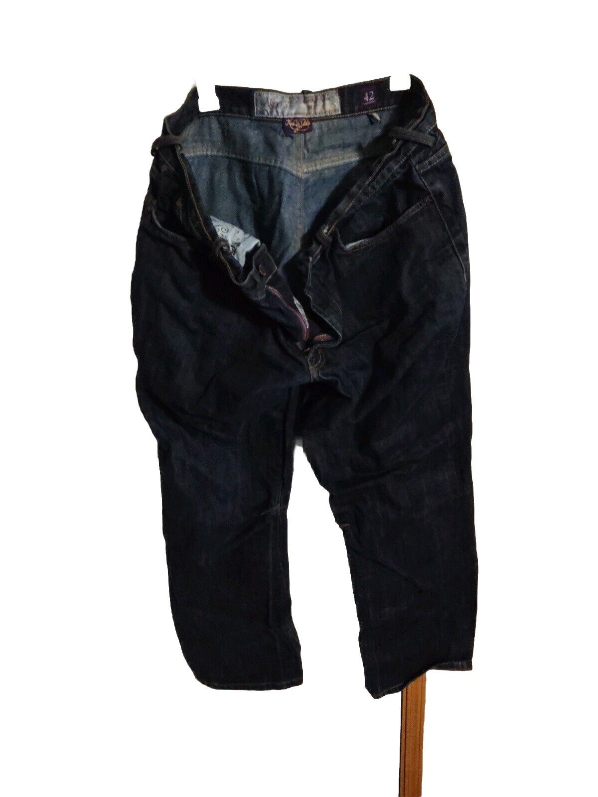 Black akoo jeans size 42 with button and zipper closure laid flat on white background