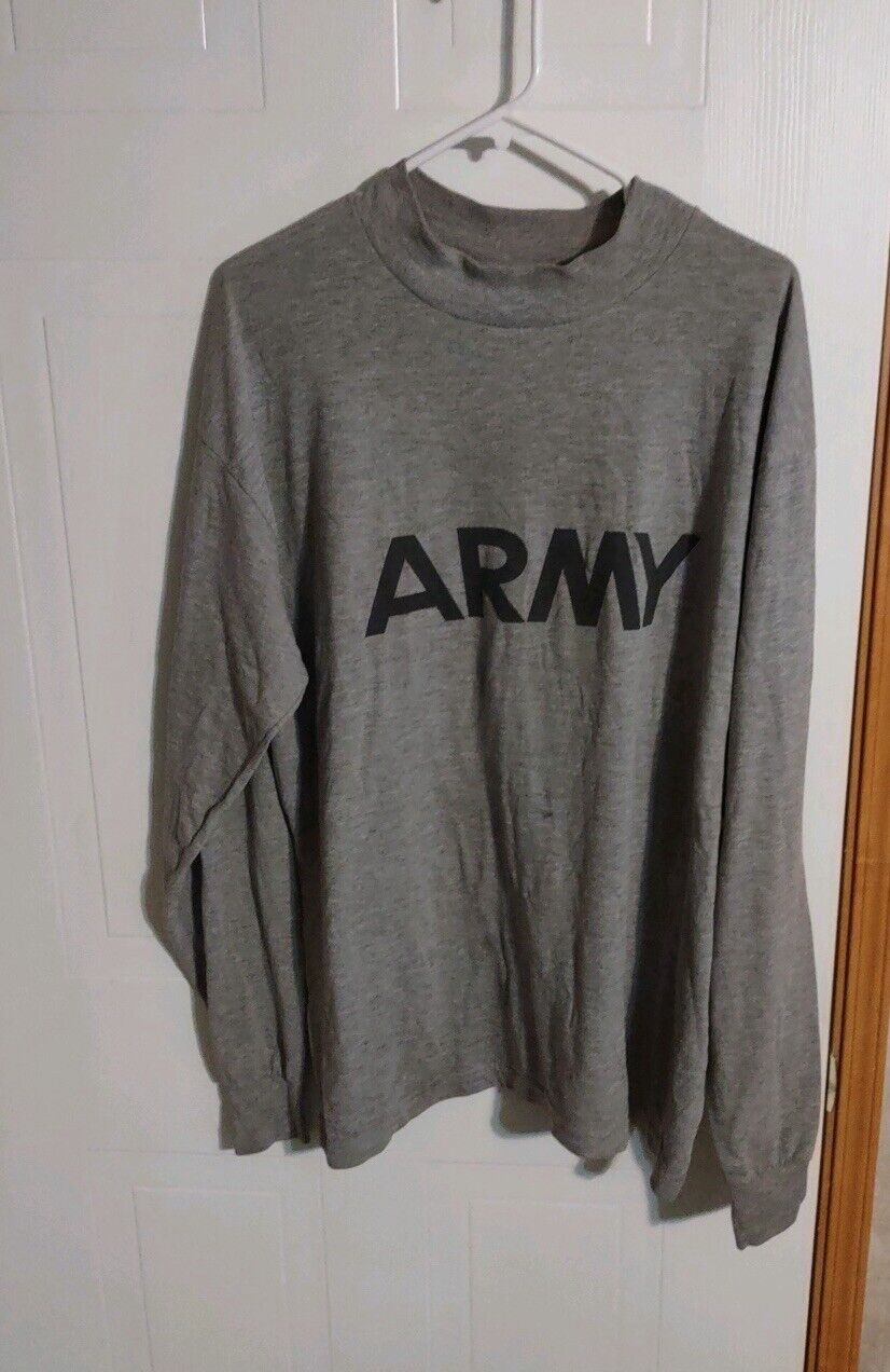 Gray AKWA Tek army shirt with black ARMY print hanging on white hanger against white door