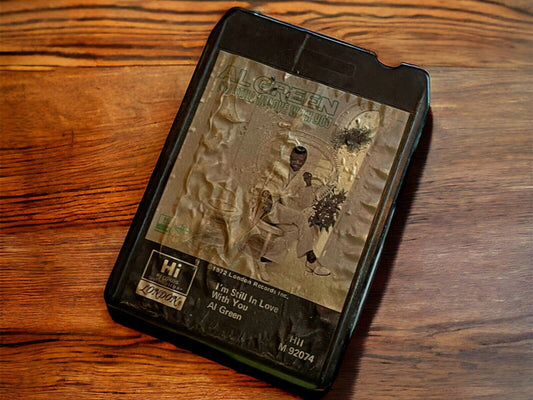 Vintage Al Green 8 track tape with worn label resting on wooden surface