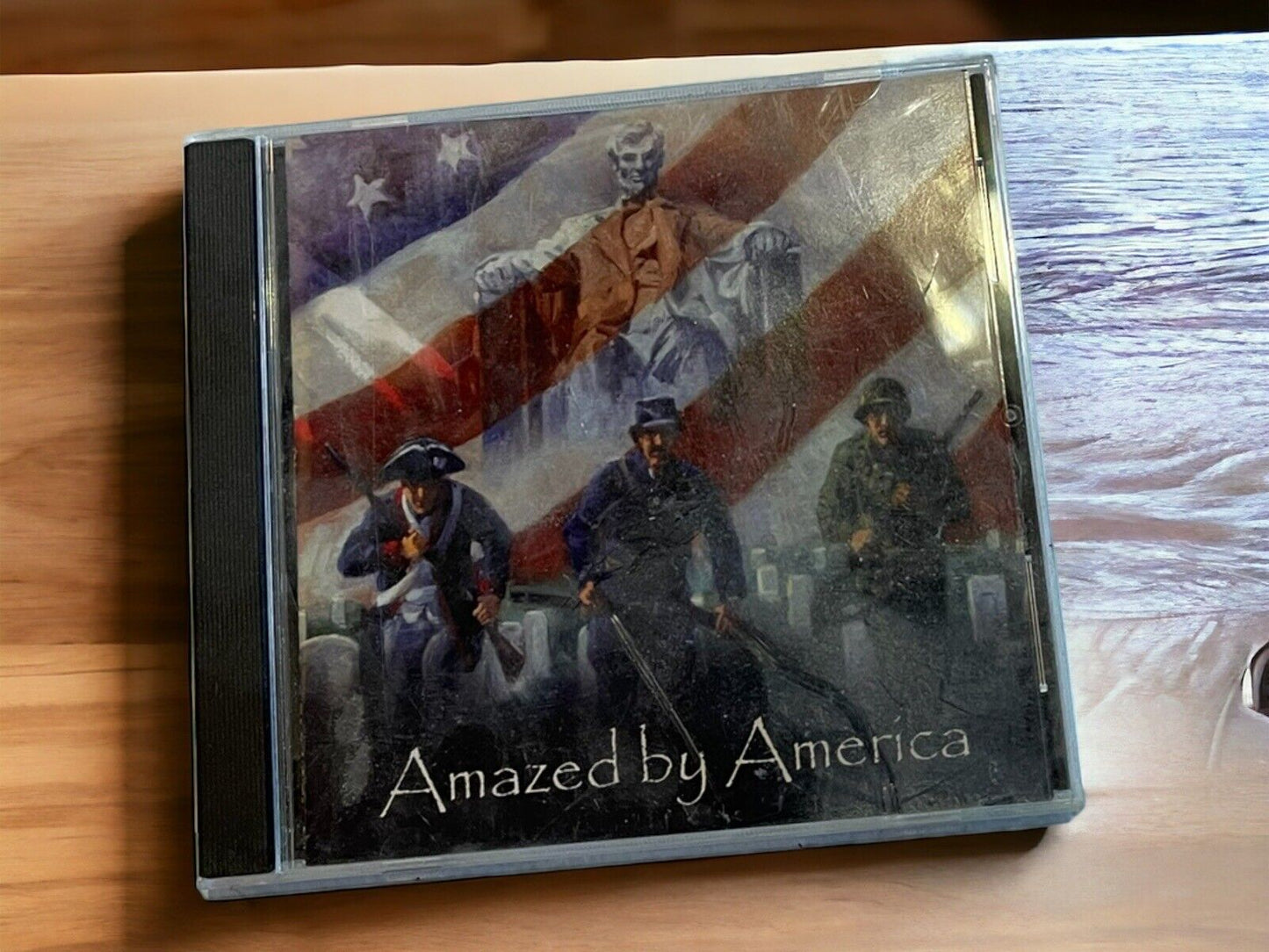 Amazed By America CD with patriotic cover featuring historical figures and American flag backdrop