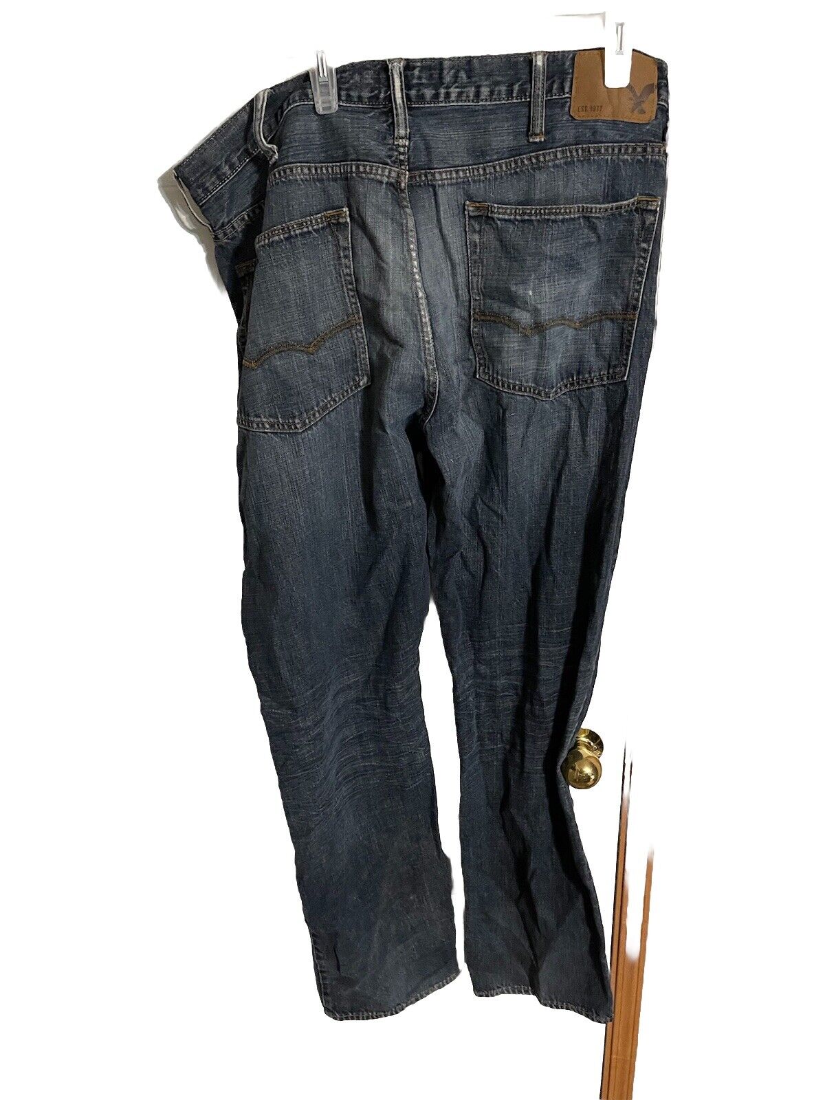 Dark wash American Eagle jeans 38x36 hanging showing back pockets and stitching details