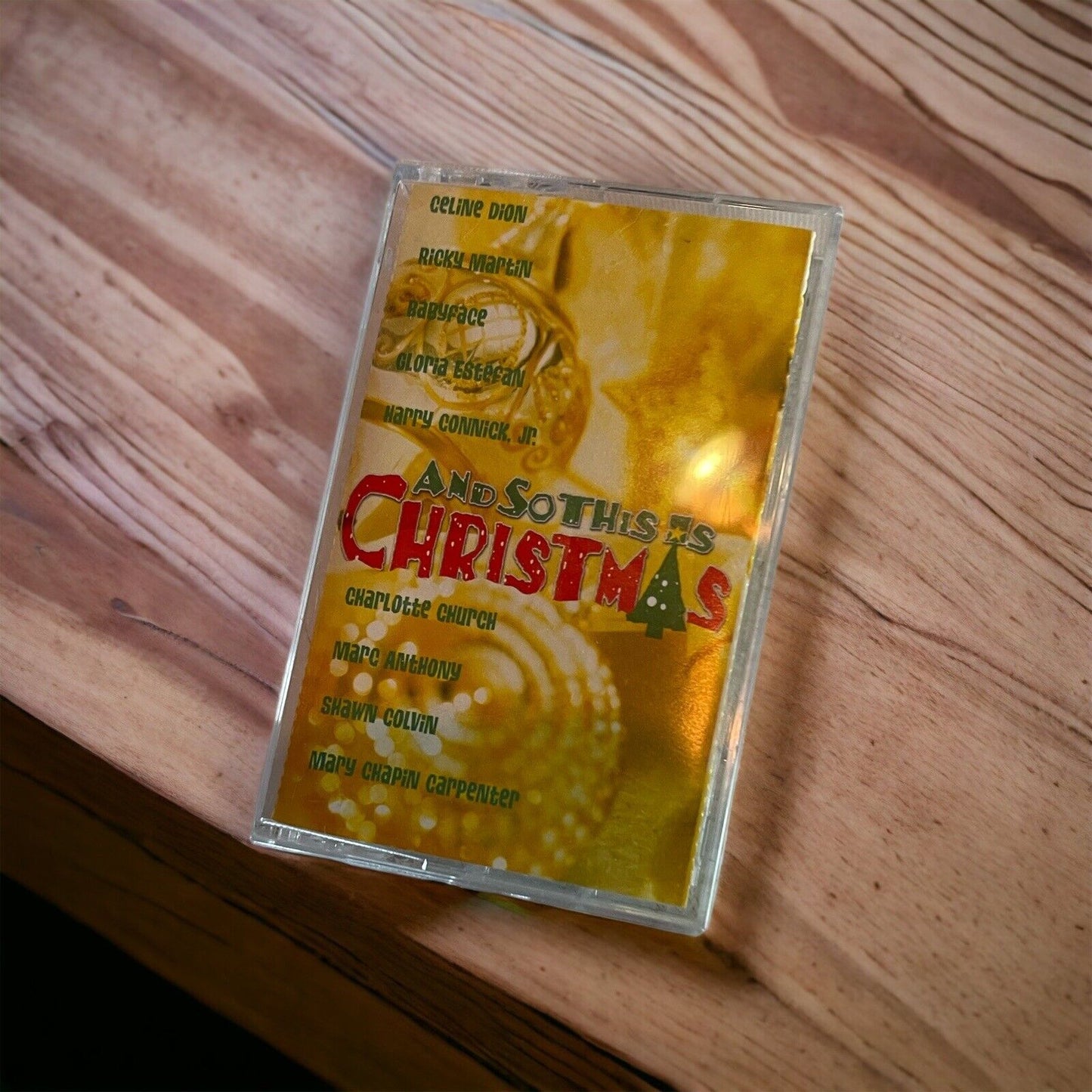 And So This Is Christmas cassette tape with festive gold cover featuring artists and holiday decorations