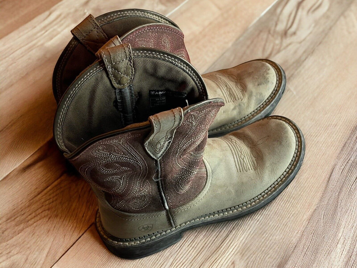 Ariat Fatbaby Heritage boots in brown leather with detailed stitching on wooden floor