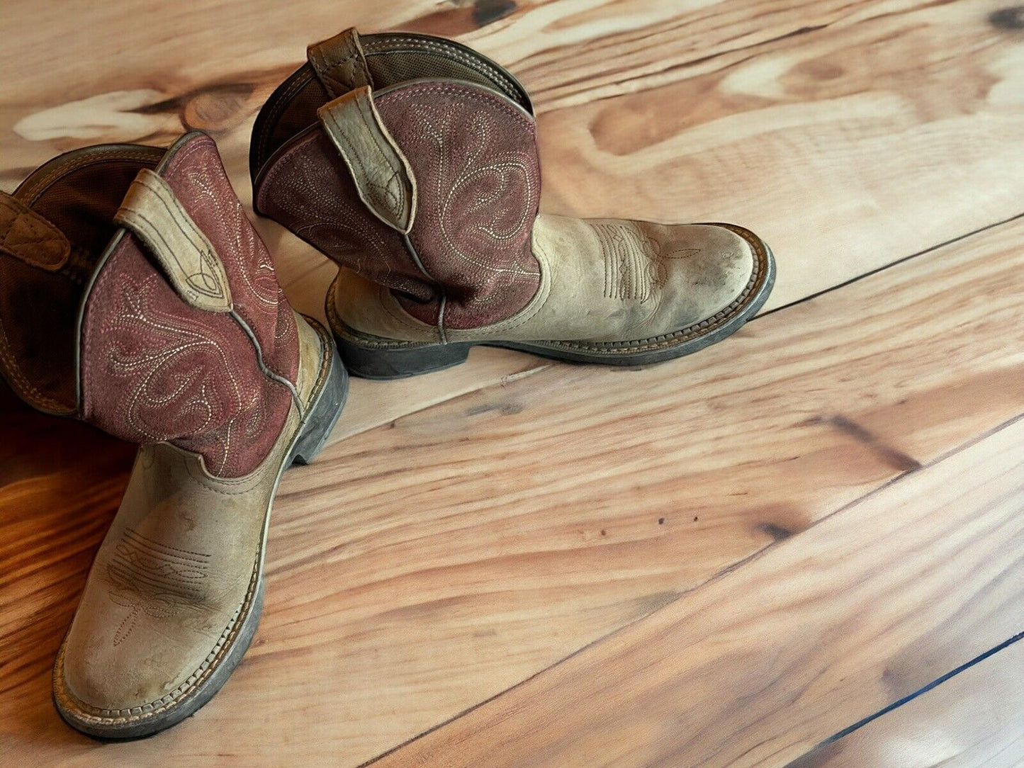 Ariat Fatbaby Heritage boots in brown and tan leather on wooden floor with detailed stitching