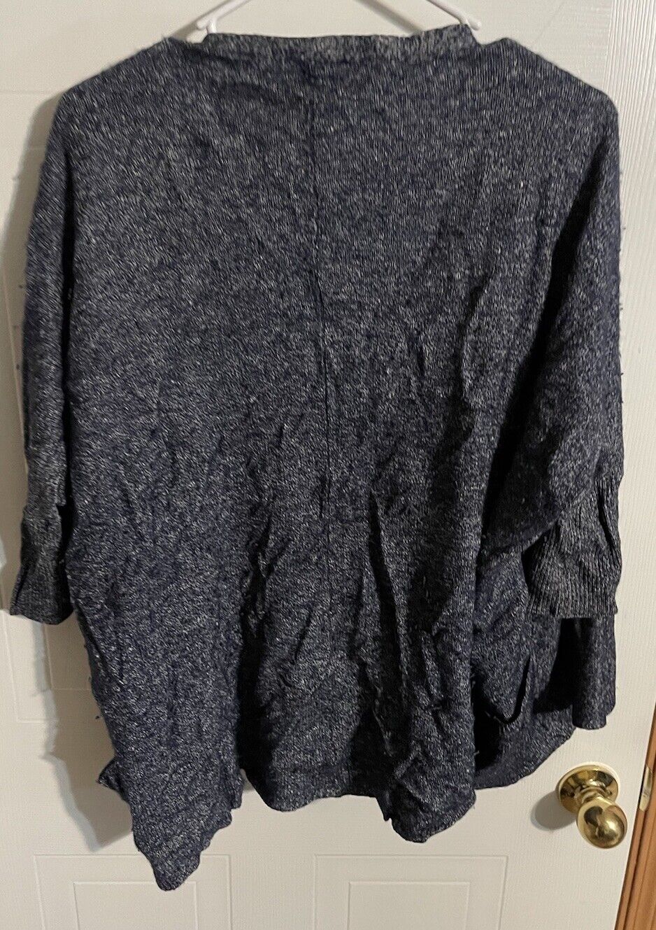 Dark gray Athleta cardigan for women with long sleeves hanging on white hanger