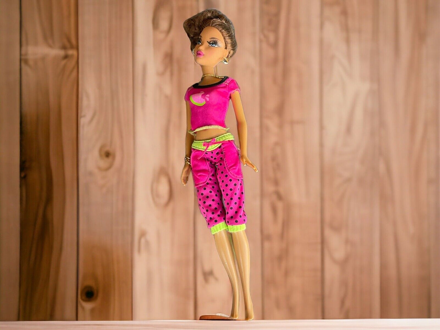 Barbie My Scene Madison doll wearing pink polka dot outfit standing against wooden background