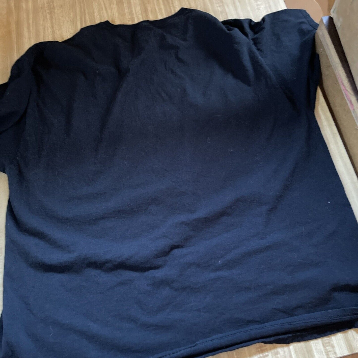 Black plain Jaws movie t shirt 3XL laid flat on wooden surface showing back side