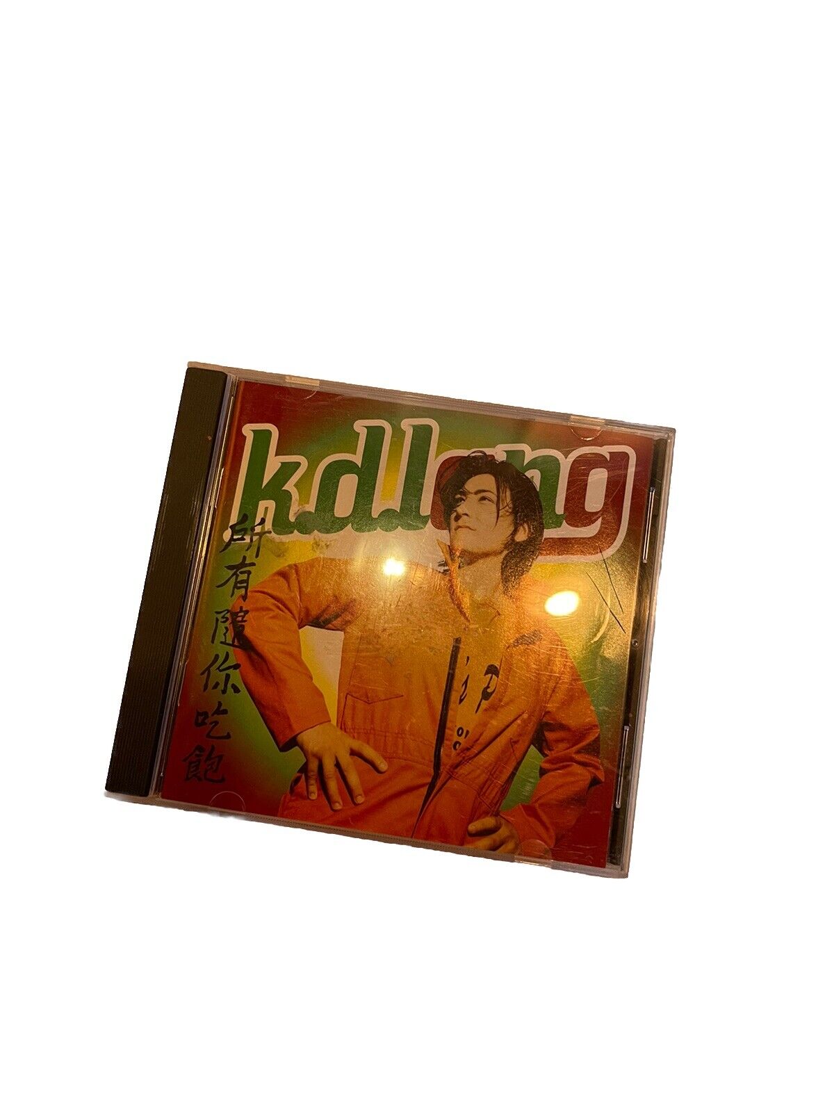 k.d. lang all you can eat CD featuring artist on colorful cover with orange jacket