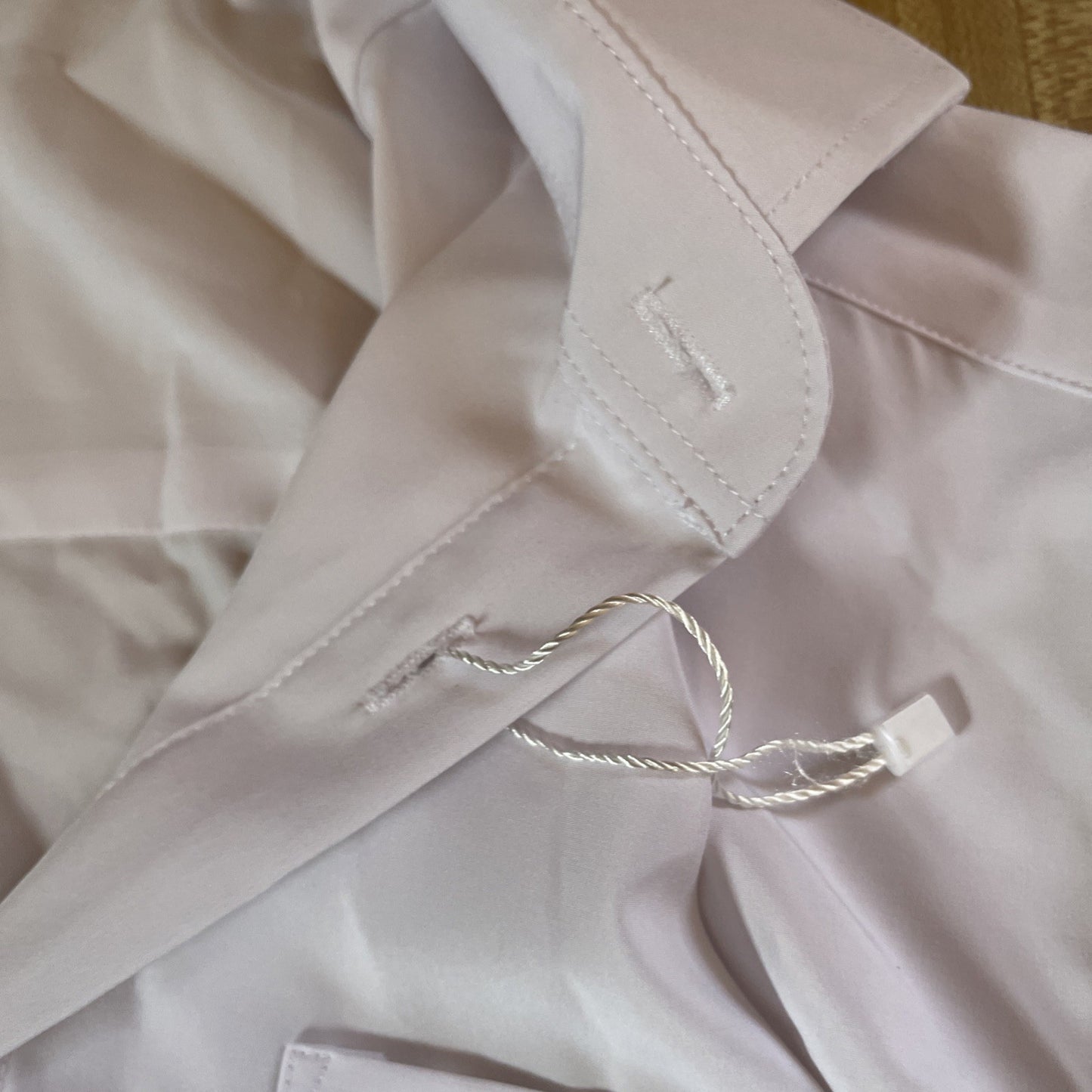 Close up of white men's athletic button up shirt from & Collar showing collar and buttonhole details
