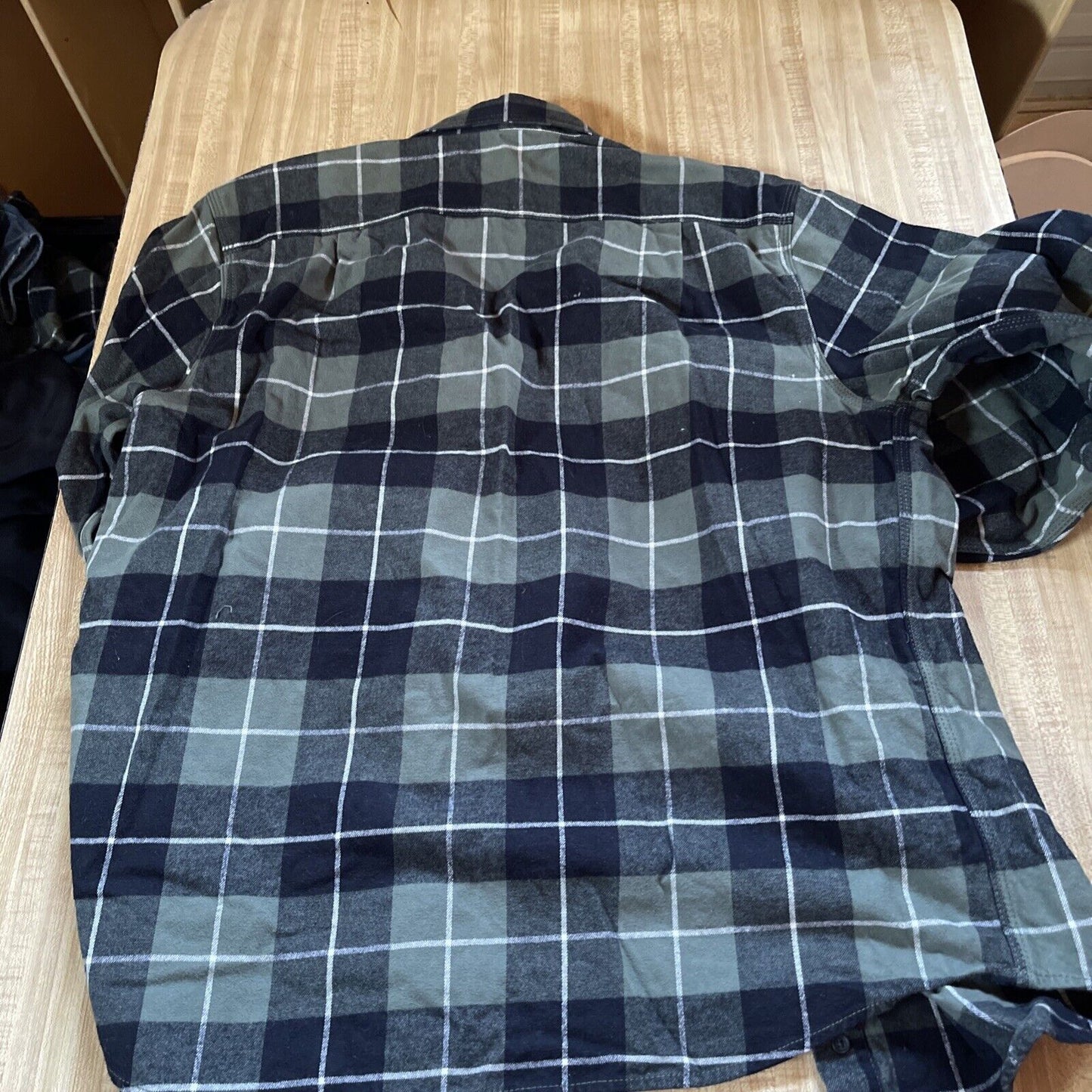 1118 Emporium men's plaid flannel shirt in dark blue and gray check pattern laid flat