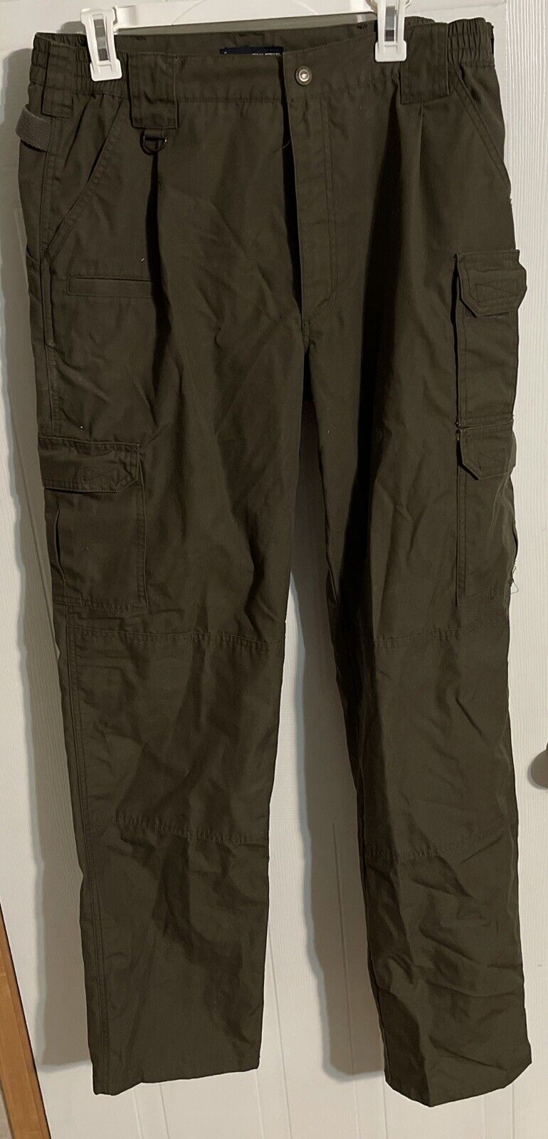 Mens tactical cargo pants in dark olive green with multiple pockets and belt loops from 1118 Emporium