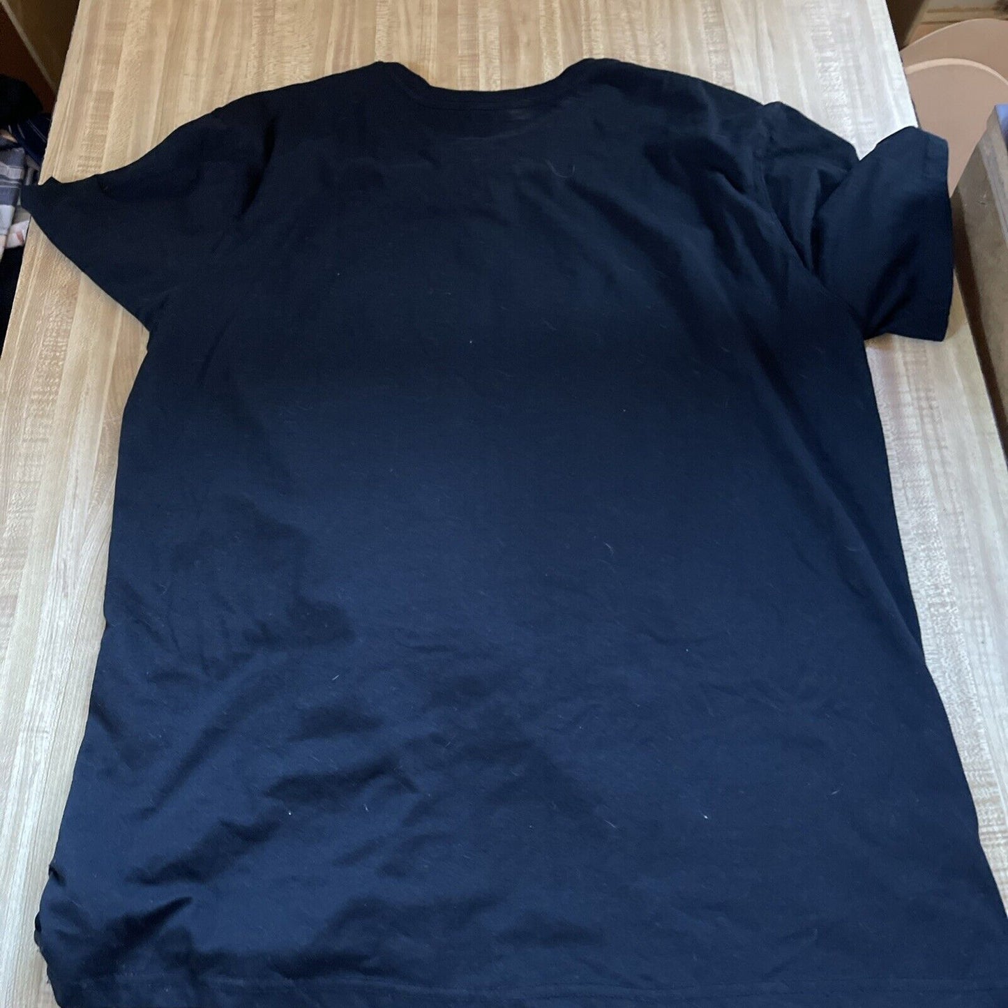 Black NBA Lakers fan apparel XL plain t-shirt laid flat on wooden surface from 1118 Emporium