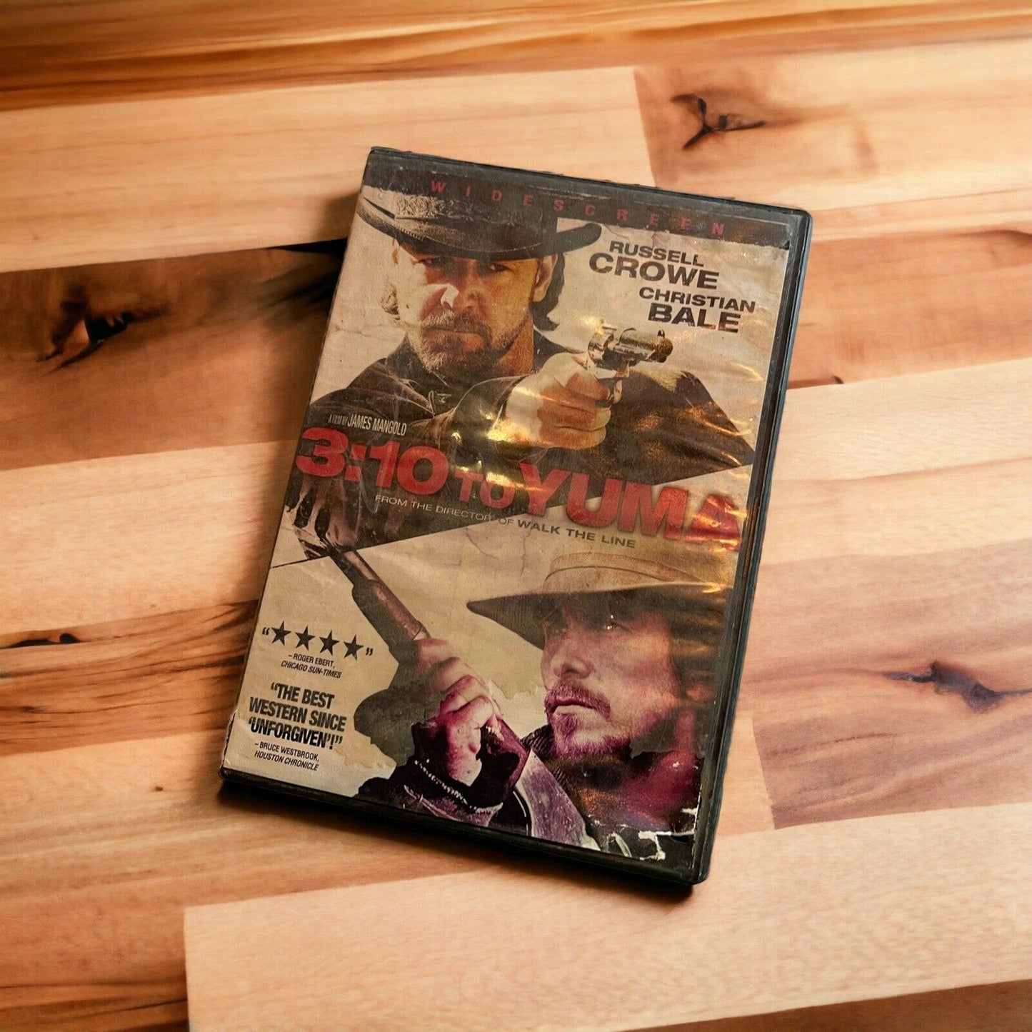 DVD case of 3:10 to Yuma featuring Russell Crowe Christian Bale western film on wooden surface
