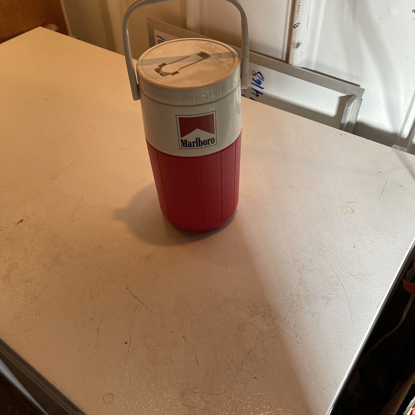 Vintage Marlboro thermos cooler in red and white with handle and Marlboro logo on front