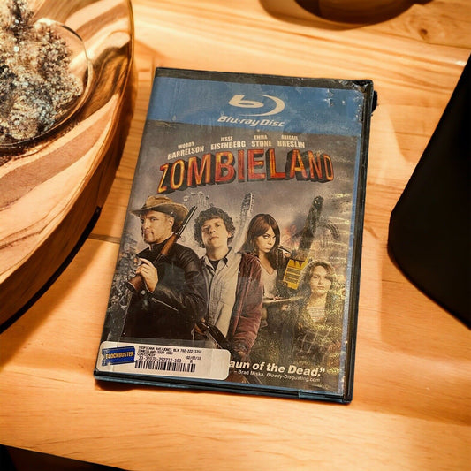 Zombieland Blu-ray 2009 movie case featuring main cast on wooden surface near decor