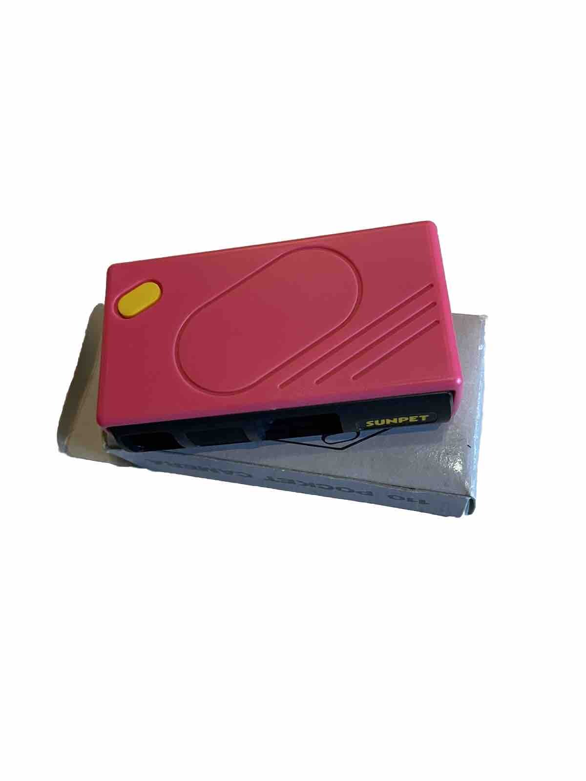 Sunpet 110 pocket camera in pink with yellow shutter button and compact rectangular design