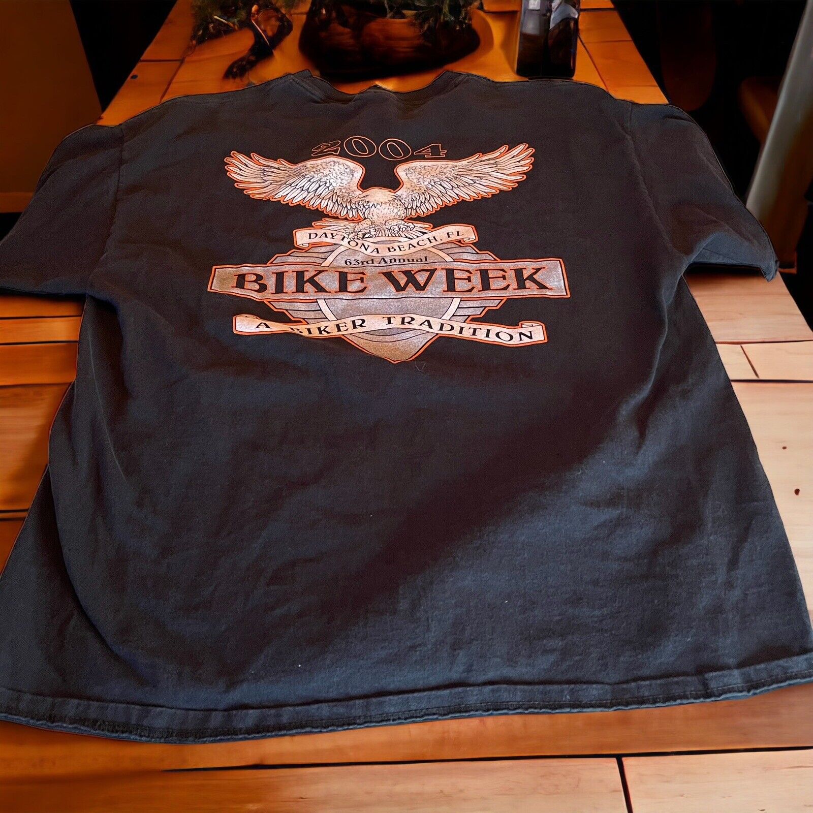 2004 Bike Week t shirt with eagle and biker tradition graphic printed on black fabric