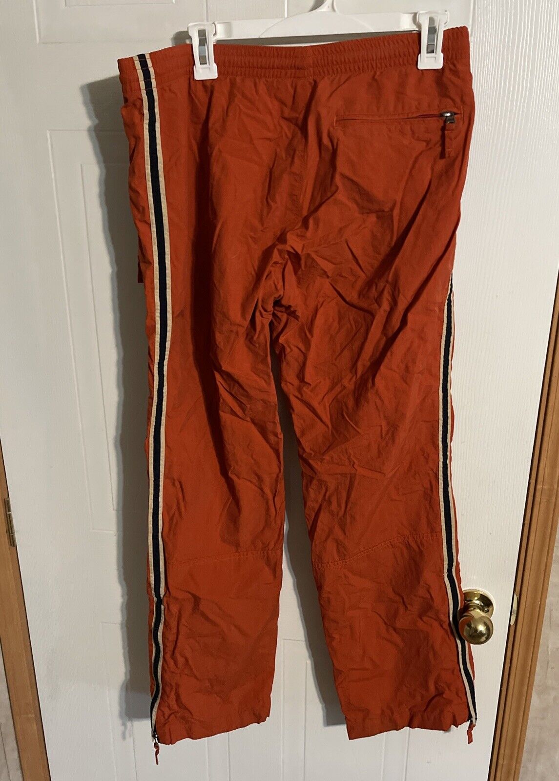 Abercrombie windbreaker pants small in burnt orange with side stripes and zippered back pocket