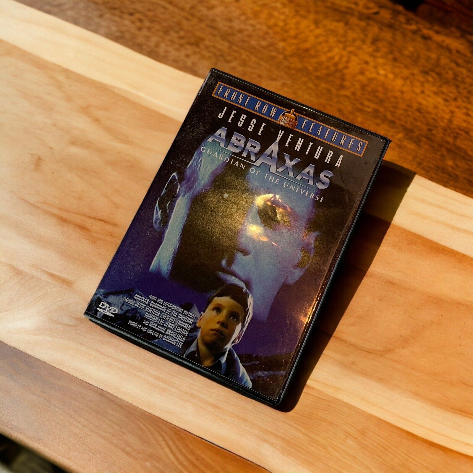 Abraxas Guardian of The Universe DVD featuring Jesse Ventura on wooden surface by 1118 Emporium