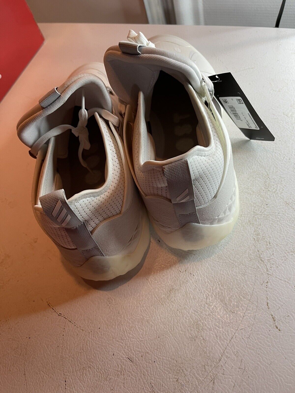 White Adidas Harden Vol 5 Futurenatural basketball shoes with pull tabs and on a white surface