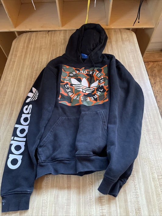 Black Adidas hoodie medium with camo logo print and white Adidas text on sleeve laid on wooden surface