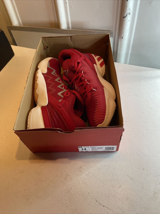 Men's red adidas basketball shoes in a red shoe box on a white surface