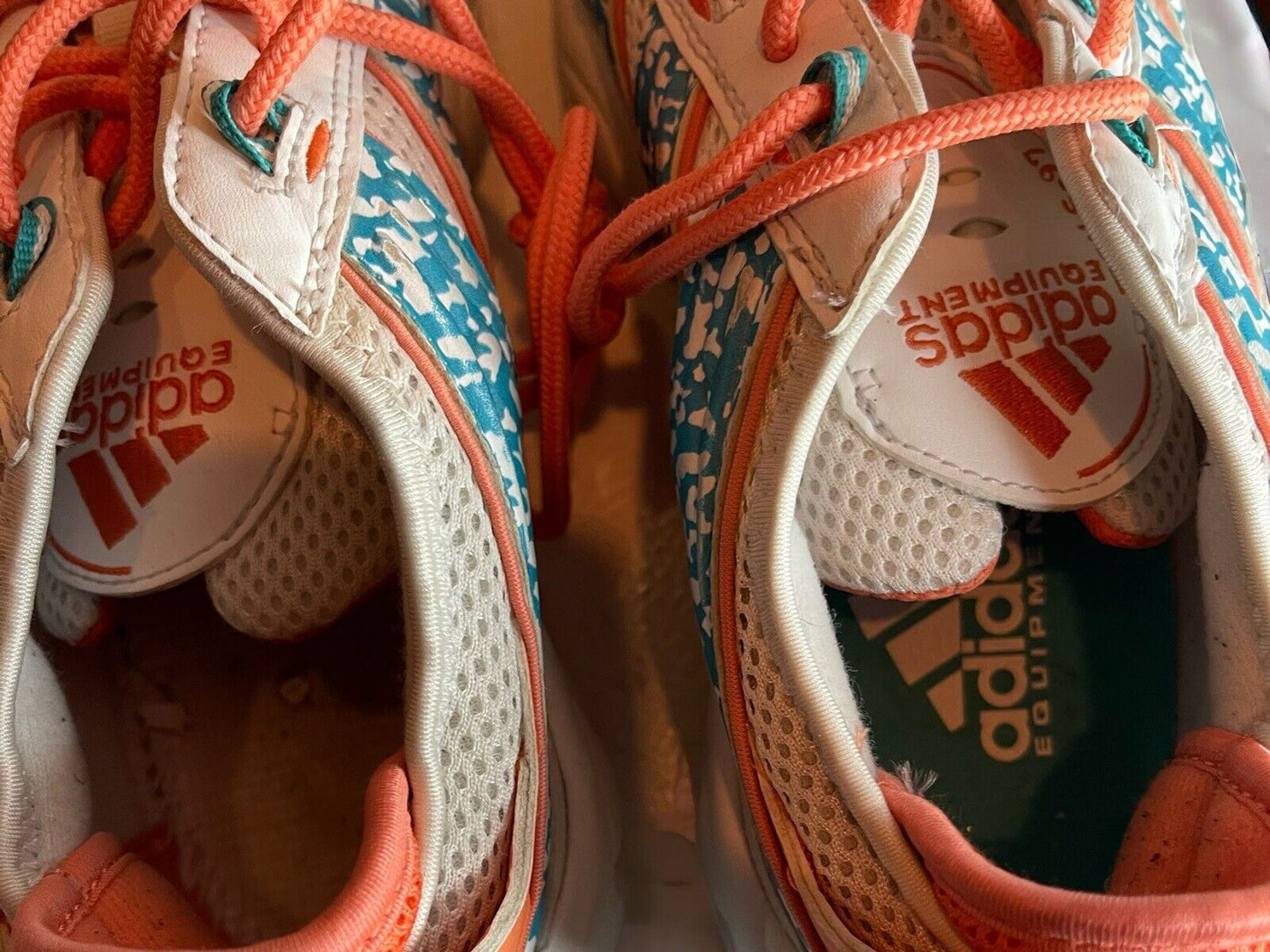 Close-up top view of Adidas Originals FYW S-97 sneakers with orange laces and blue patterned details