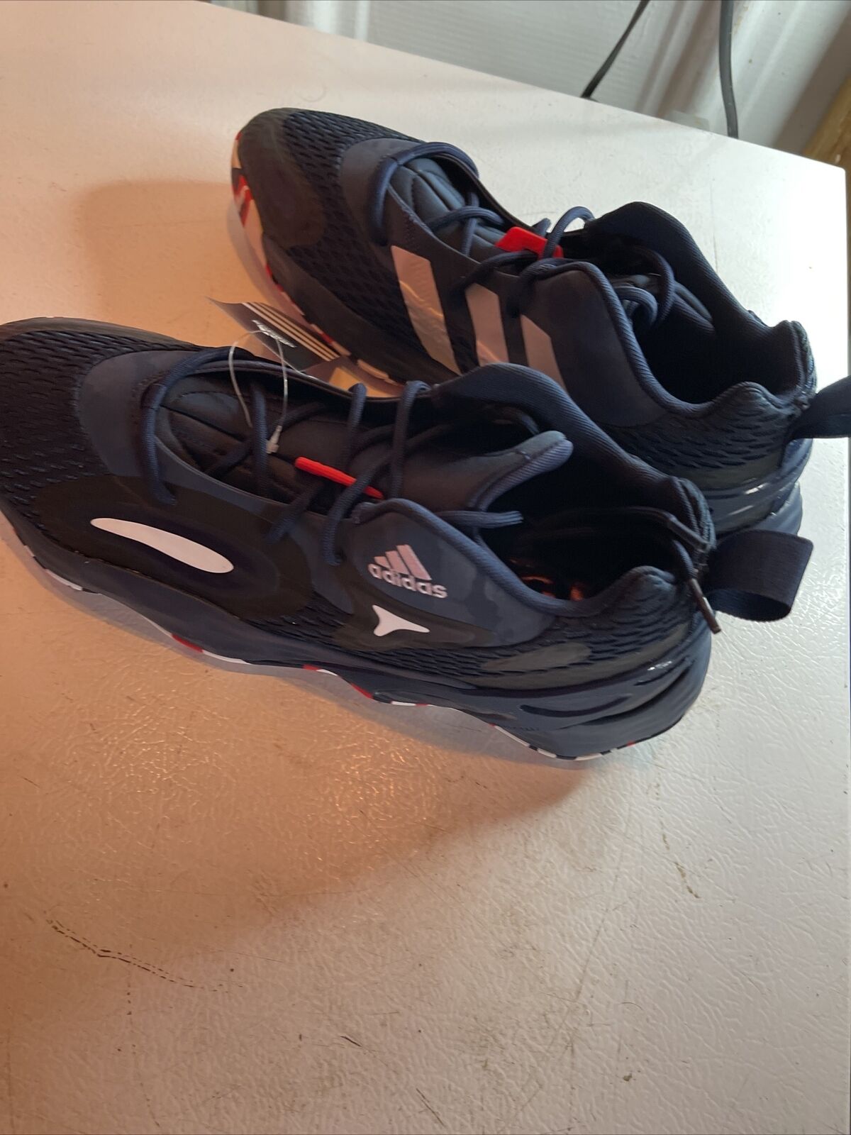 Black Adidas SM Exhibit A Team USA athletic shoes with red and white accents for running